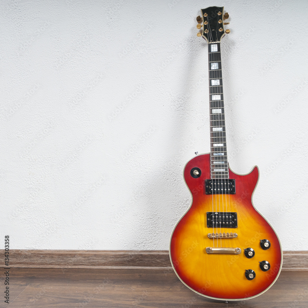 Fototapeta premium Vintage electric guitar about a white wall