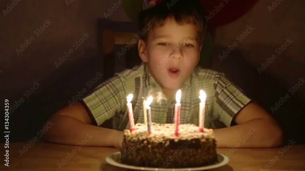 Boy blowing the candles on birthday cake Boy blowing the candles on birthday cake
