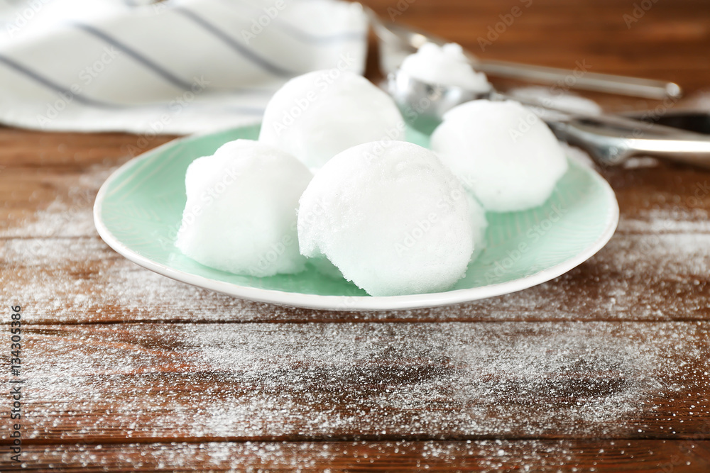 Plate with snow ice cream on wooden table Plate with snow ice cream on wooden table
