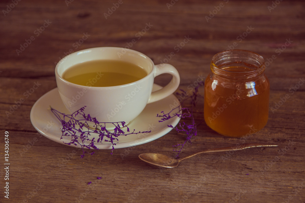 Cup of tea with honey in jar on the wooden table Cup of tea with honey in jar on the wooden table
