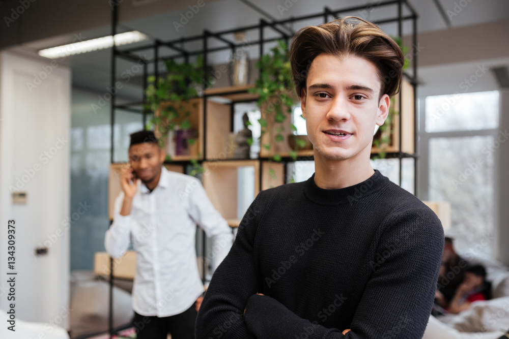 Photo of two young handsome students in library