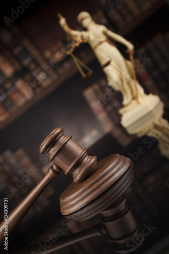 Antique statue of justice, law, books background