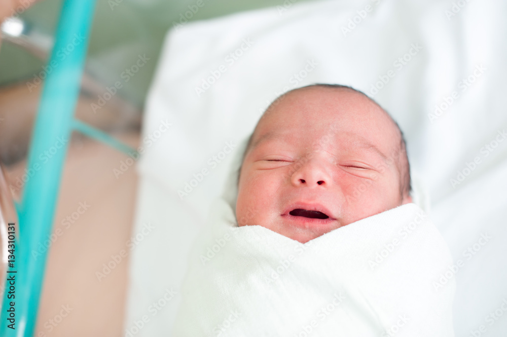 Newborn baby in hospital with id ribbon on his hand Newborn baby in hospital with id ribbon on his hand