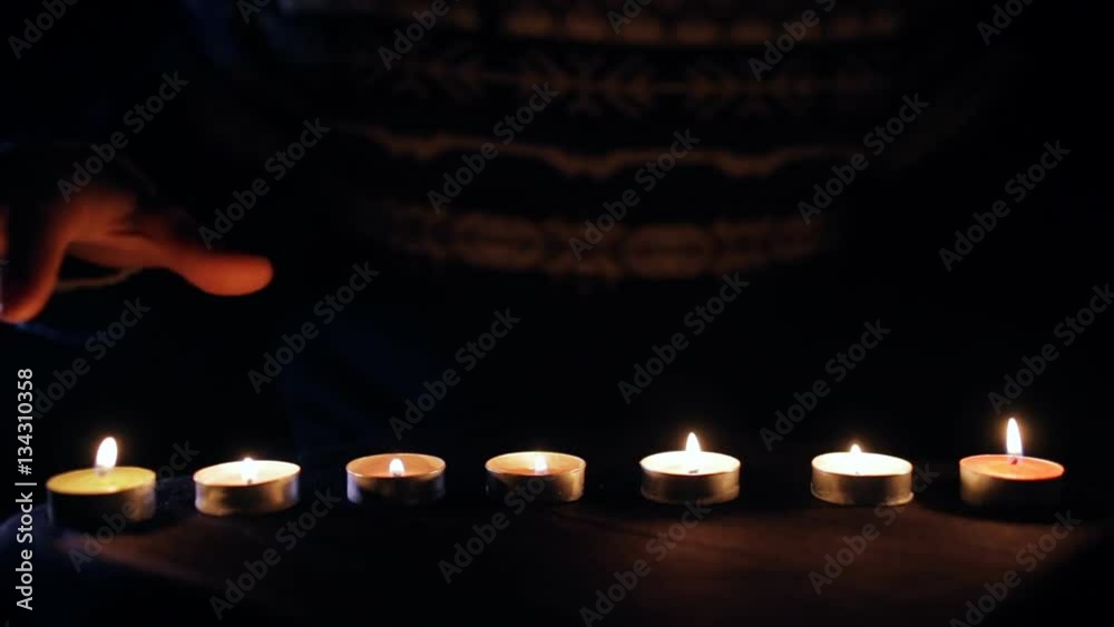 Wizard conjure with hands above burning candles Wizard conjure with hands above burning candles