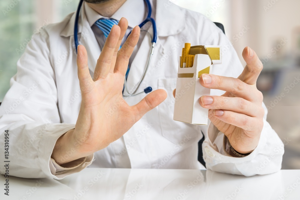 Doctor is warning against smoking cigarettes and giving advice to quit smoking. Doctor is warning against smoking cigarettes and giving advice to quit smoking.