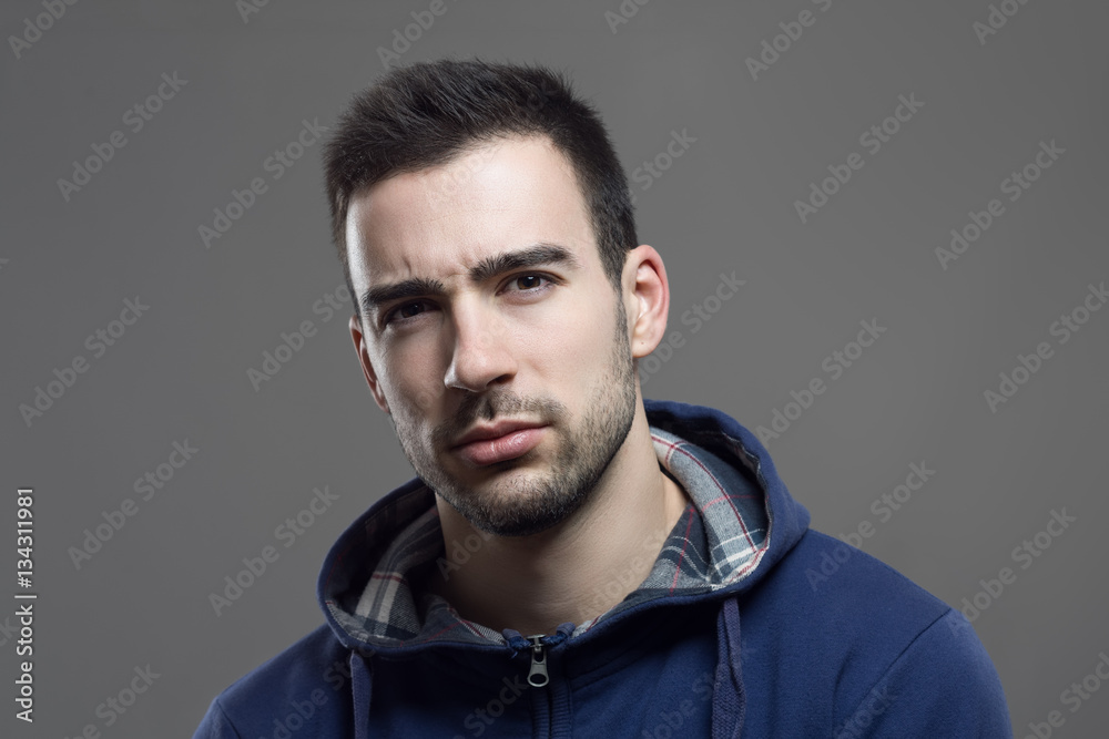 Obraz premium Skeptical distrustful young man looking dubious at camera with disbelief. 