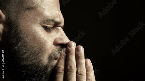 Profile of a young man praying photo