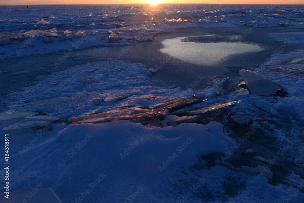Finnish Bay of Baltic Sea Photo Landscape break thin ice in the light of sunset