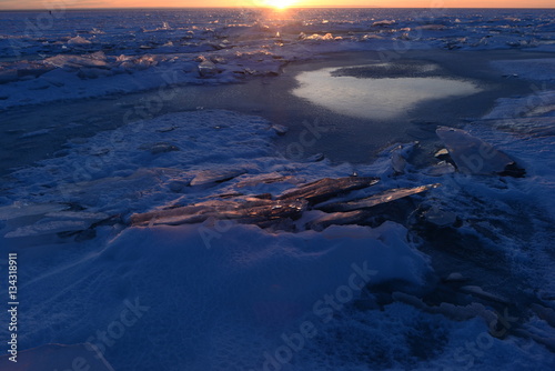 Finnish Bay of Baltic Sea Photo Landscape break thin ice in the light of sunset