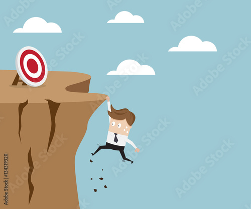 businessman hold on the cliff for target