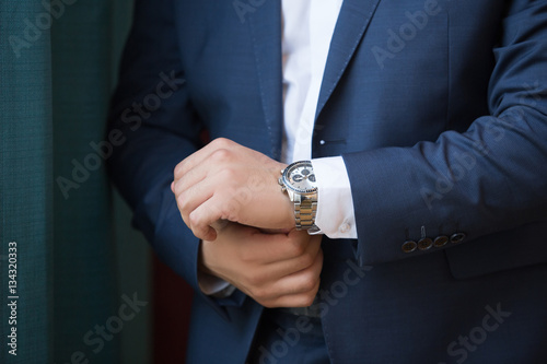 A close up of an expensive elegant watch on a hand of the business man. business concept