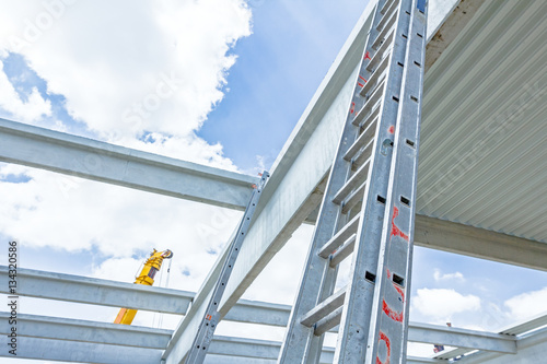 Aluminum ladder pointing towards on next level, concrete edifice