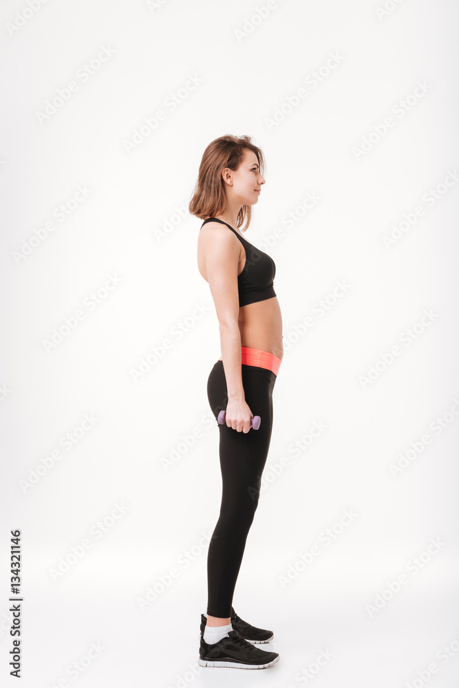 Pretty young fitness lady make exercises with dumbbells Pretty young fitness lady make exercises with dumbbells