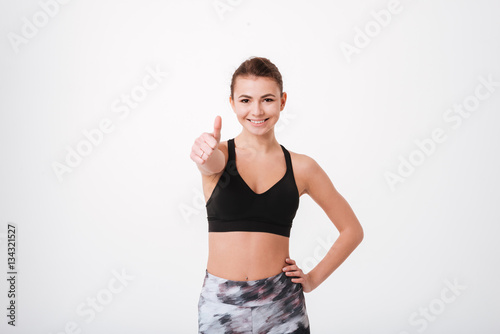Attractive young fitness lady make thumbs up gesture