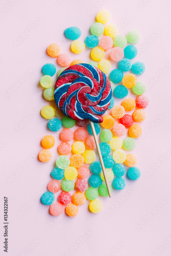 lollipop with candies on pink background, unhealthy junk food
