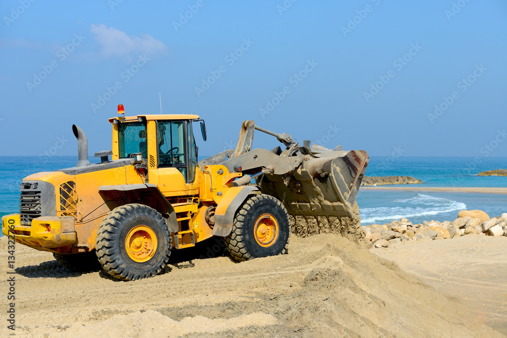 bulldozer working on a beach