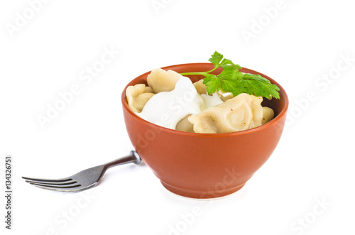 Ceramic bowl with meat dumplings, and fork near