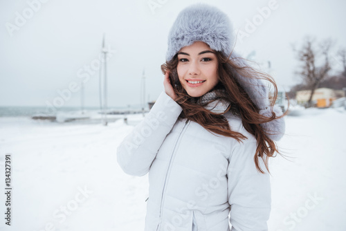 Gorgeous young lady wearing hat at cold winter day