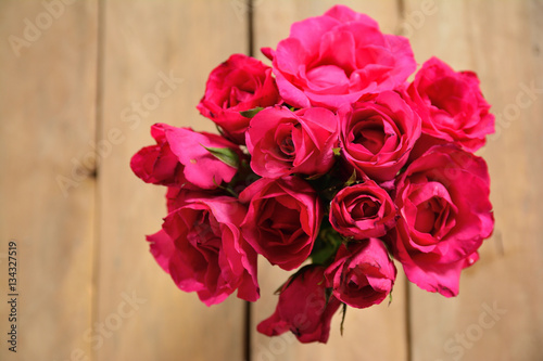 red roses on wooden table