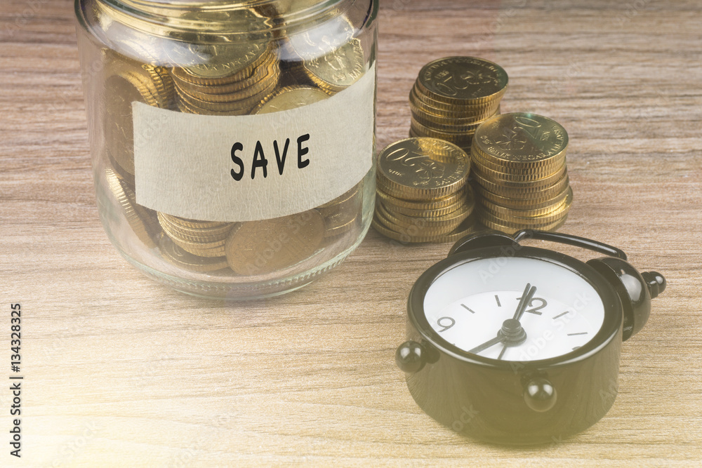 Coins in glass with SAVE label on wooden background. Financial concept. Coins in glass with SAVE label on wooden background. Financial concept.