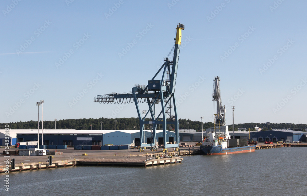 Cargo cranes in the seaport on white background
