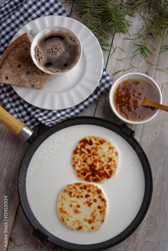 Cheese in milk, cloudberry jam, and coffee