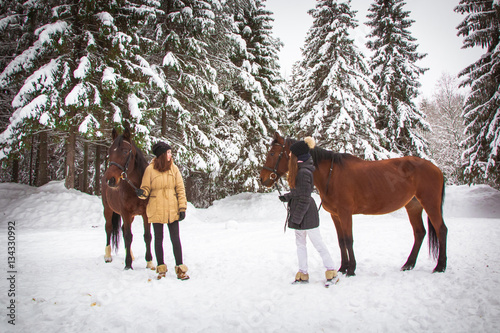 Twin sisters and horse in the winter forest © keleny