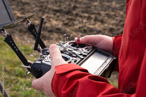 Man use remote control to controls drone photo