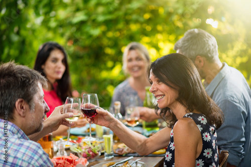 Group of friends lunching around a table on a terrace