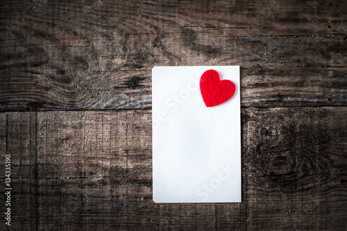 Valentines day Card with gift boxes and  hearts, blank white card for messaage  and red hearts on dark wooden background  photo