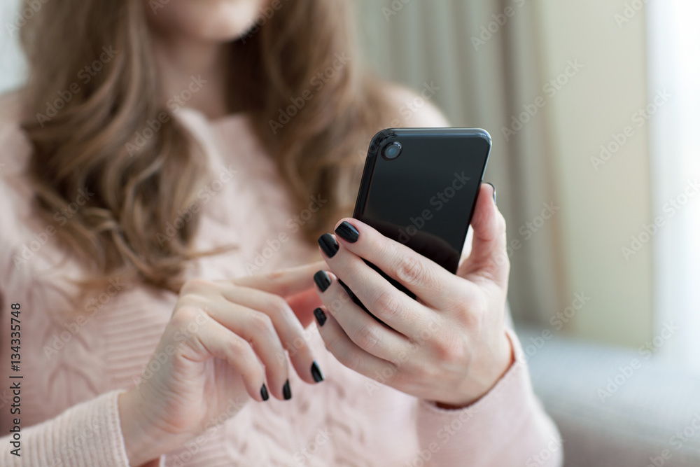 woman holding black touch phone