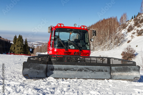 Red snowcat in mountains of Kazakhstan in ski resort