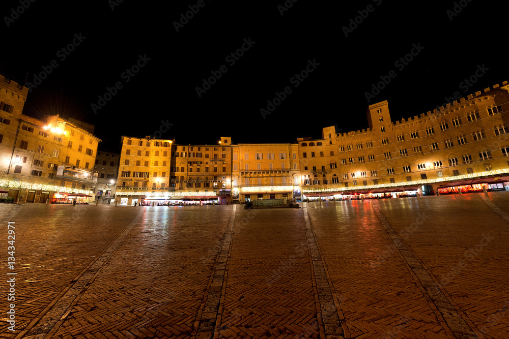 Piazza del Campo (Campo square) by night in the downtown of Siena, Tuscany, Italy
