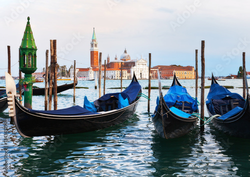 Venetian gondolas near the pier of San Marco in the background of the island of San Giorgio Maggiore. Venice, Italy © Katvic