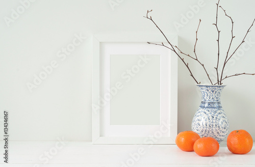 Minimal elegant composition with tangerines and vase photo