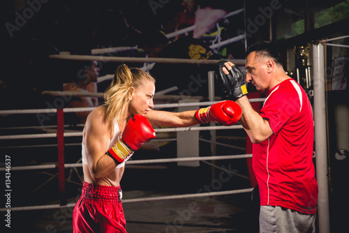 Professional boxing woman training with her instructor