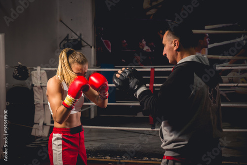 Girl Training on mitts with her boxing instructor © ildintorlak