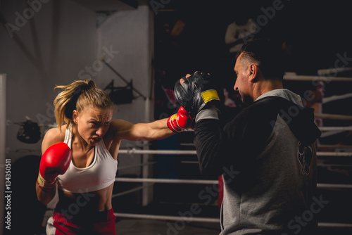 Girl Training on mitts with her boxing instructor © ildintorlak