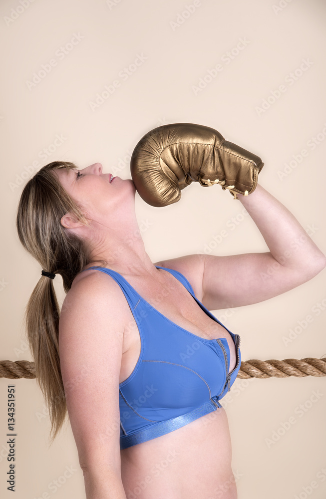 Woman Boxer Wearing Golden Gloves And A Sports Bra Stock Photo