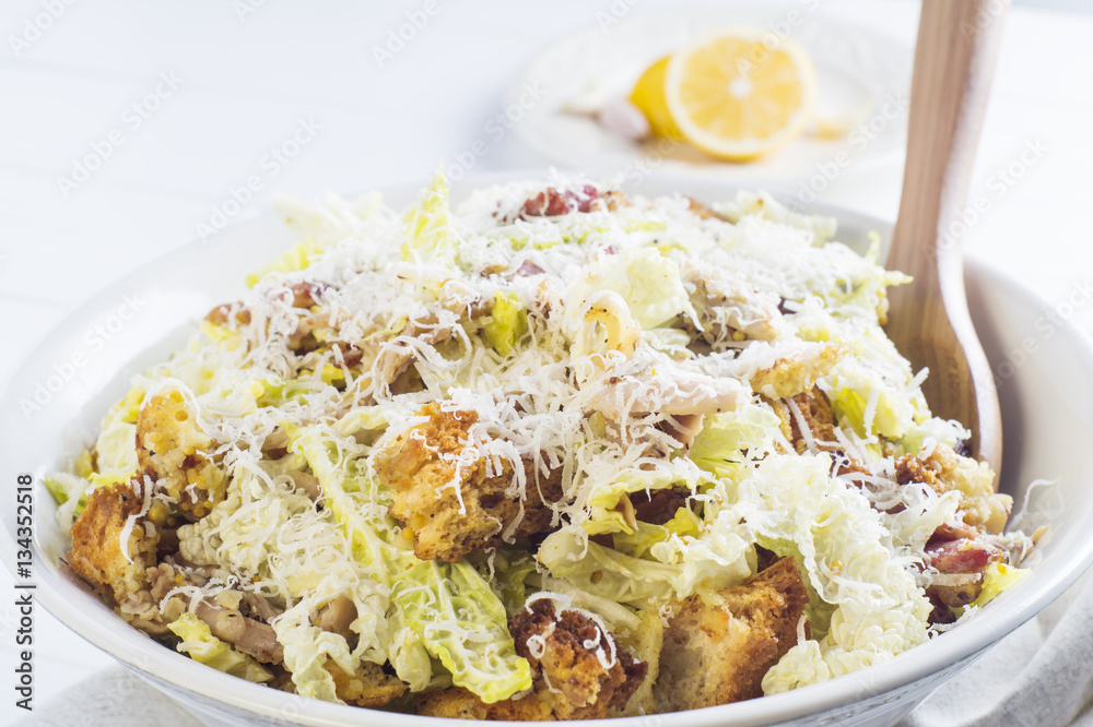 Caesar Salad with on white plate. Delicious Caeser salad with croutons, roasted chicken meat, parmesan cheese and cos lettuce, with sauce, healthy recipe, close-up. Healthy food. Caesar Salad with on white plate. Delicious Caeser salad with croutons, roasted chicken meat, parmesan cheese and cos lettuce, with sauce, healthy recipe, close-up. Healthy food.