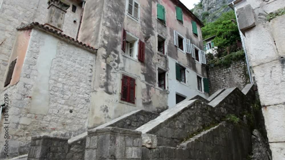Grand staircase is near dwelling living houses in old town of Kotor. Medieval fort inner area is a popular tourist place for visiting. Montenegro, Europe Grand staircase is near dwelling living houses in old town of Kotor. Medieval fort inner area is a popular tourist place for visiting. Montenegro, Europe