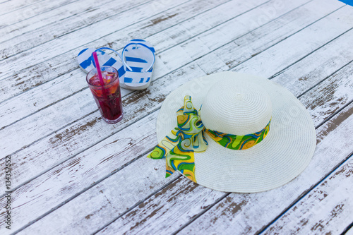 Pair of colored sandals on a white summer wooden floor