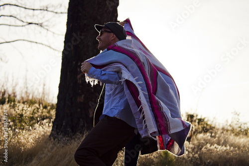 Man draped in blanket 