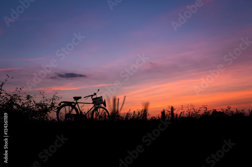 Bicycle silhouette in nature sunset golden hour evening with twi