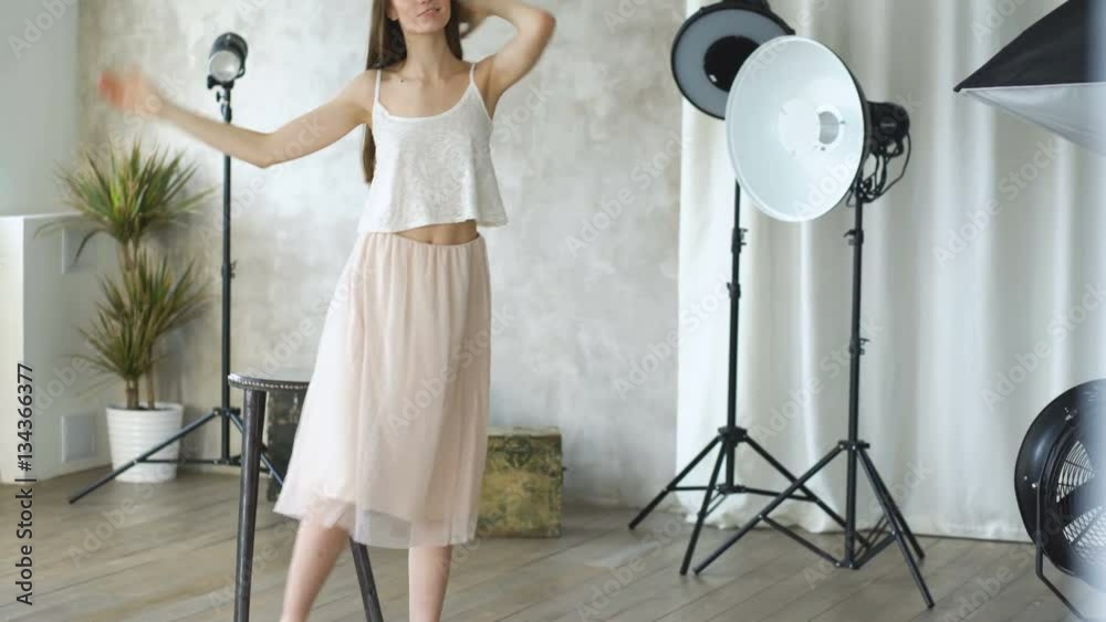 Professional fashion model posing and looking into camera. Woman show ...