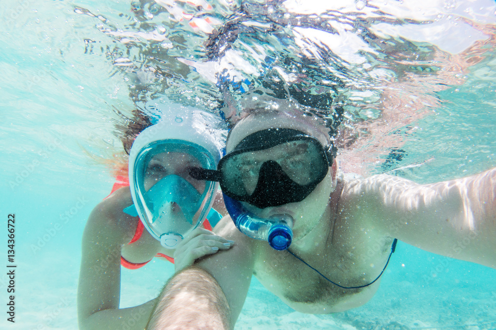 Naklejka premium A couple in love taking selfie underwater in Indian Ocean, Maldives