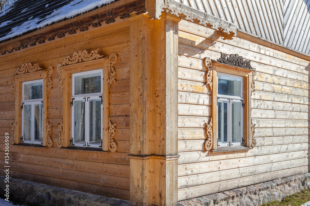 New wooden house wall in traditional carving style