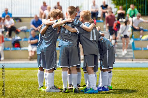 Youth Sports Team. Children's Football Team on the Pitch. Boys in Grey Soccer Shirts Standing Together on the Football Field. Motivated Young Soccer Players Before the Final Game of School Tournament
