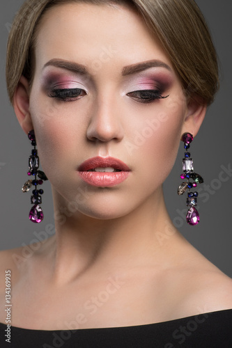 Closeup portrait of beautiful young woman with creative makeup