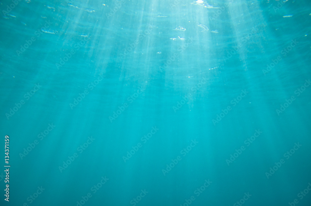 Underwater blue background with sun rays Underwater blue background with sun rays
